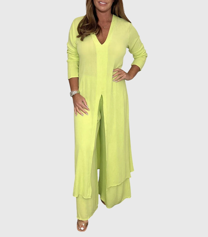 Woman wearing a light green dress with a matching cardigan on a white background