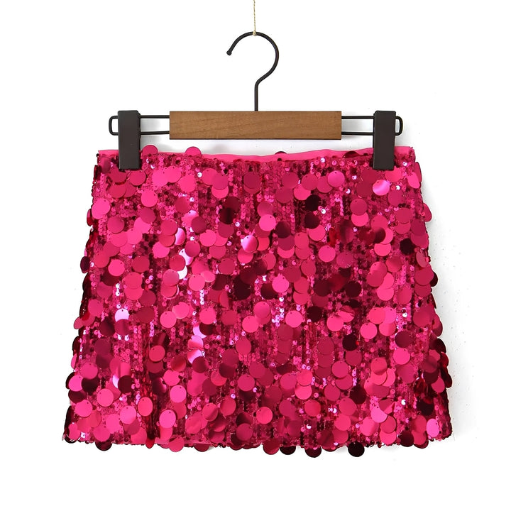 Pink sequin skirt on a hanger against a white background