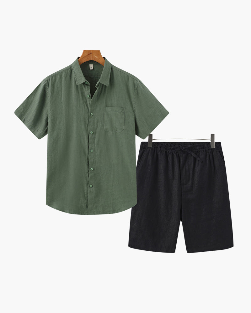 Green shirt and black shorts on hangers against a white background