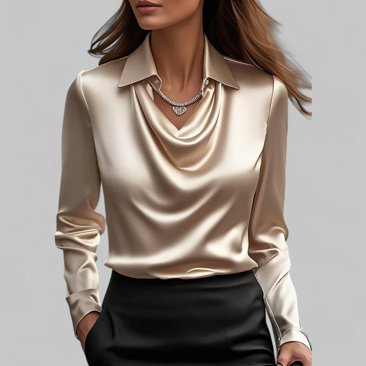 Beige long-sleeve top worn by a person on a gray background
