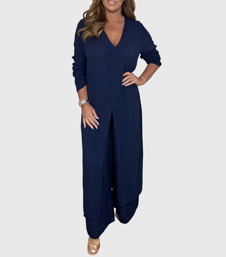 Woman wearing a navy blue jumpsuit on a white background