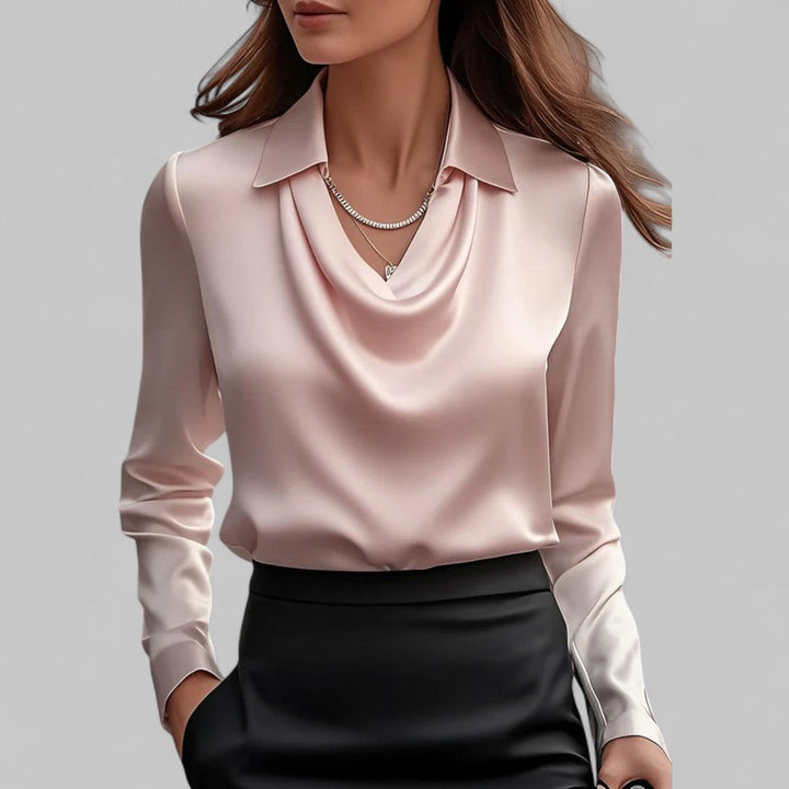 Woman wearing a pink blouse with a plain background