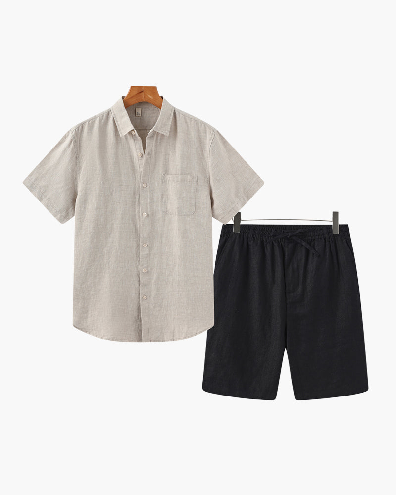 Beige shirt and black shorts on hangers against a white background