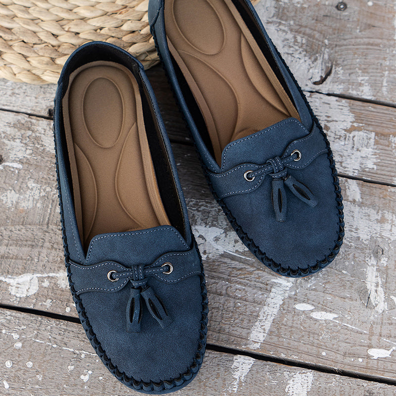 Pair of blue loafers on a wooden surface
