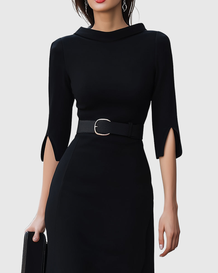 Black dress with a belt worn by a model on a white background