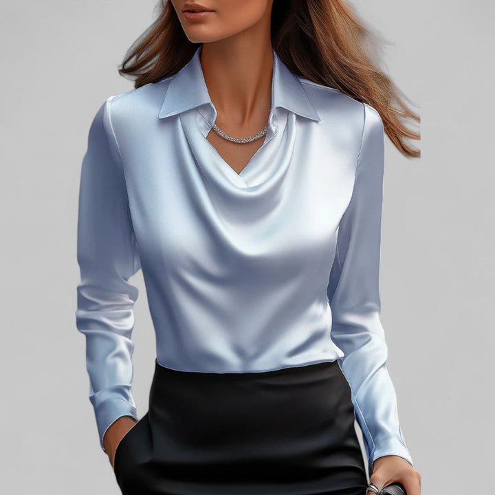 Light blue blouse worn by a person on a gray background