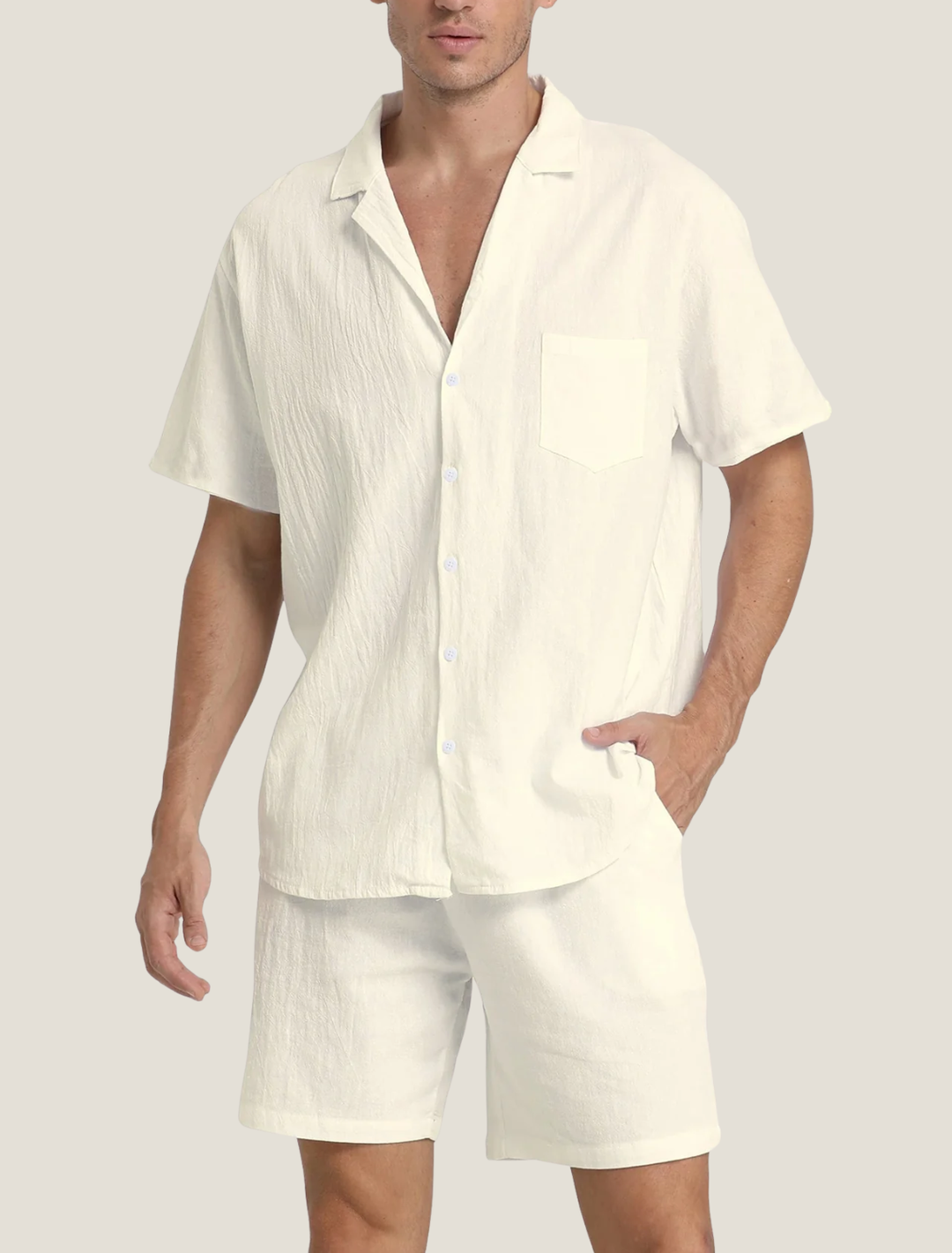 Man wearing a cream-colored shirt and shorts set on a plain background