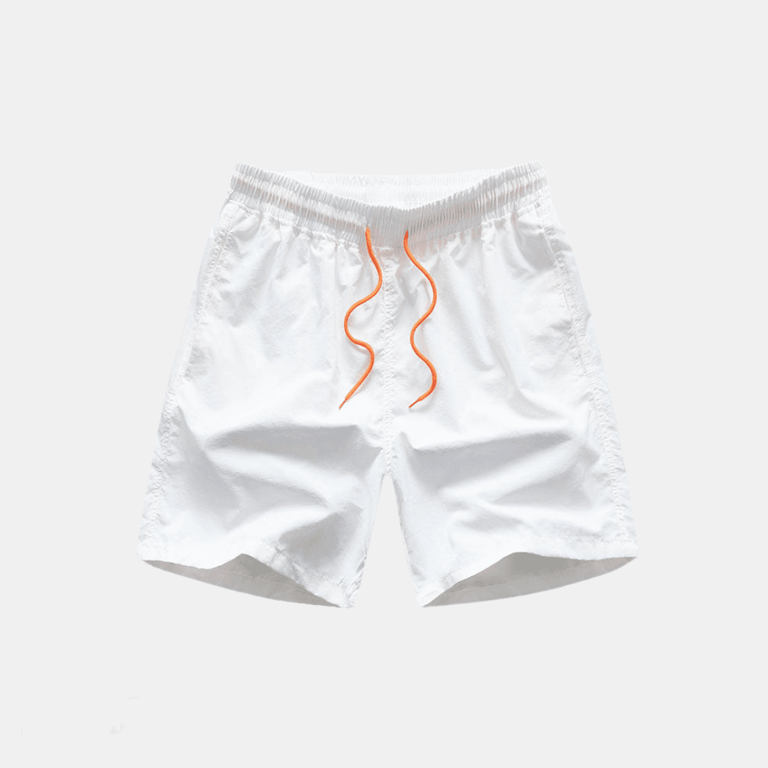 White baby bloomers with orange accents on a light gray background