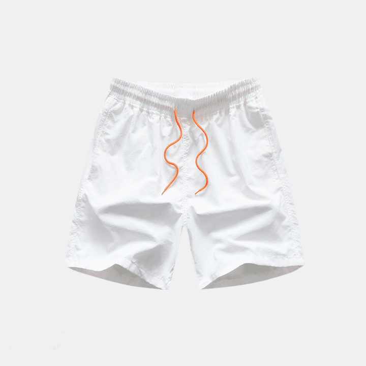 White baby bloomers with orange accents on a light gray background