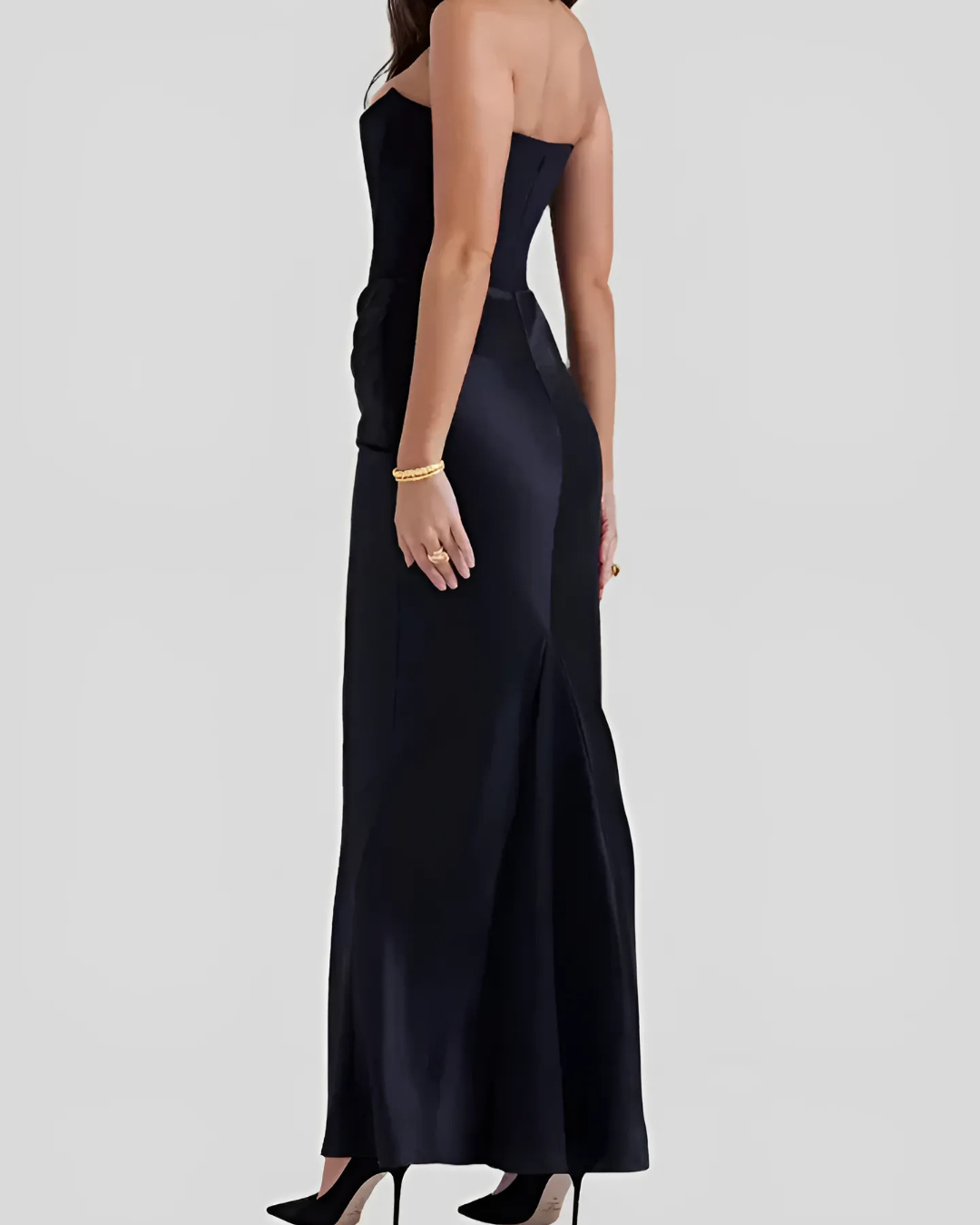 Black strapless gown on a plain background