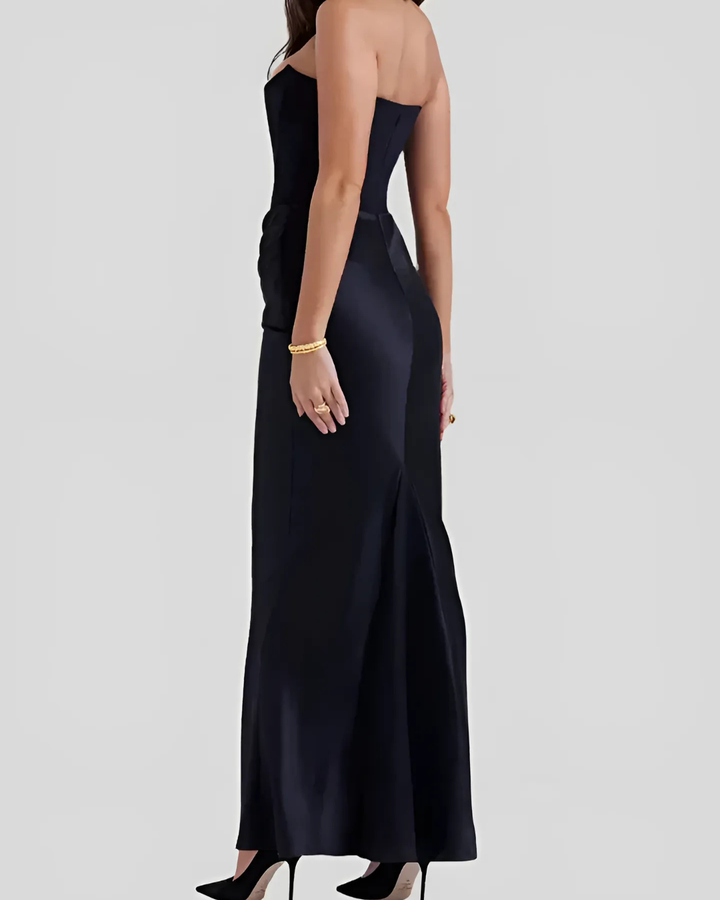 Black strapless gown on a plain background