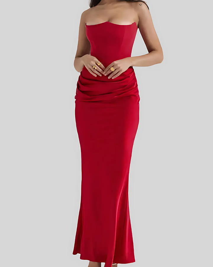 Red strapless gown on a plain background