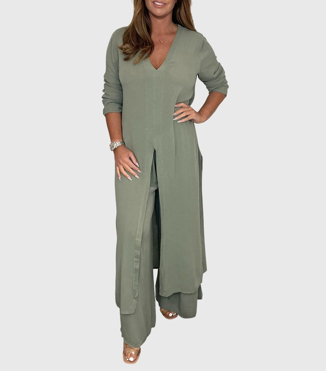 Woman wearing a long olive green dress on a white background