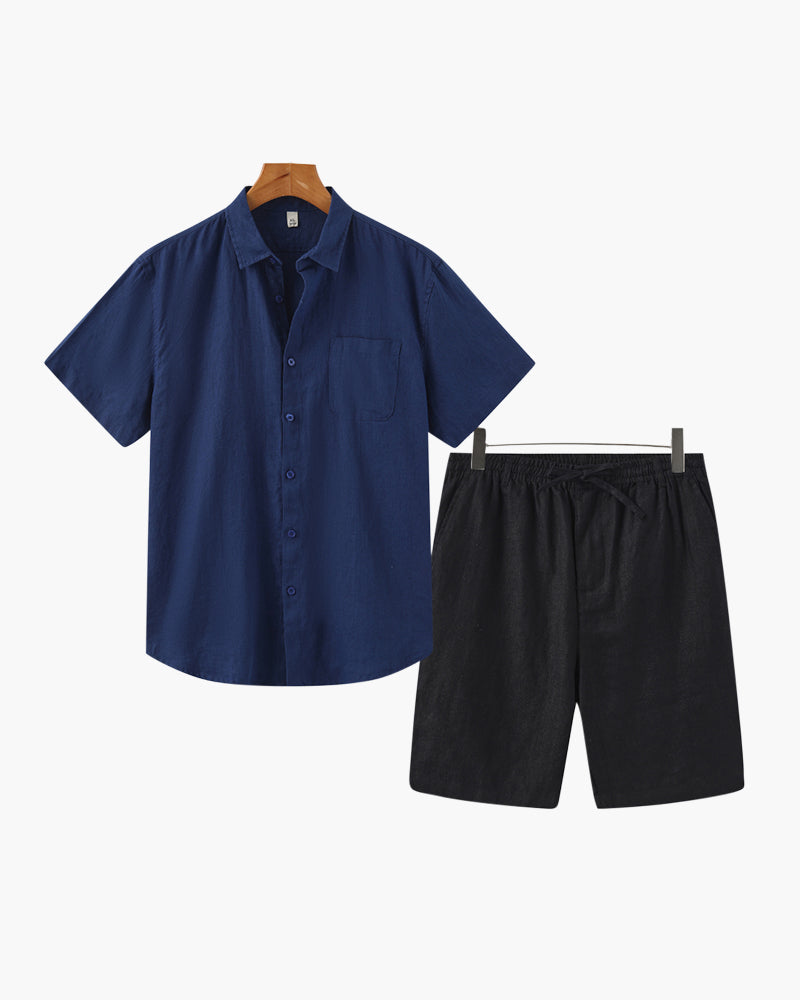 Navy shirt and black shorts on hangers against a white background