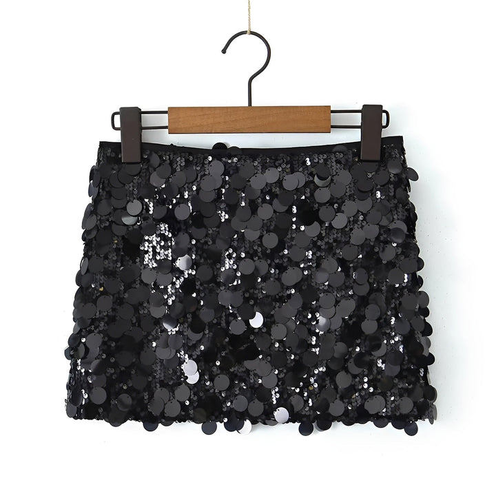Black sequin skirt on a hanger against a white background