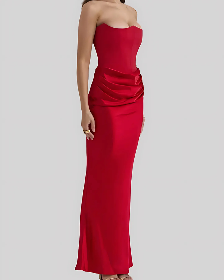 Red strapless gown on a plain background