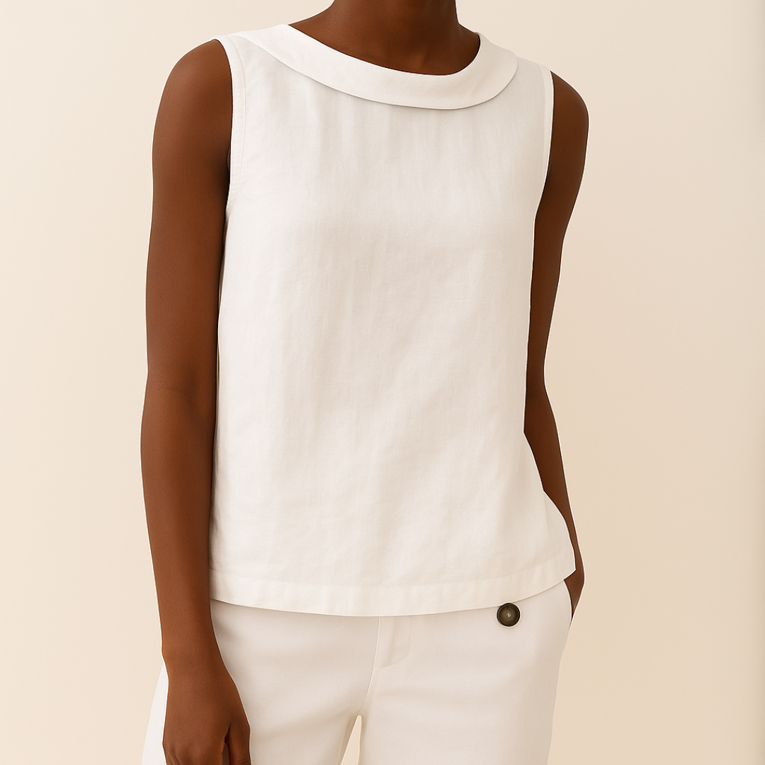 White sleeveless top worn by a person on a beige background