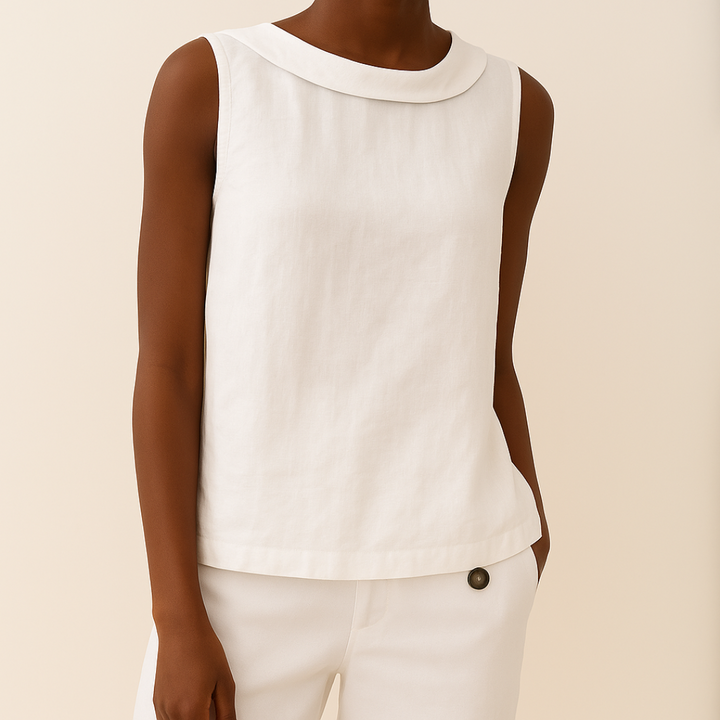 White sleeveless top worn by a person on a beige background