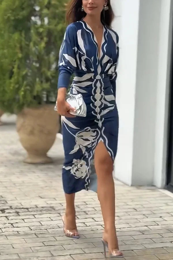 Woman wearing a blue and white patterned dress outdoors.
