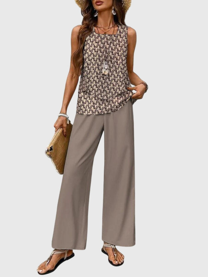 Woman wearing a patterned top and wide-leg pants on a white background