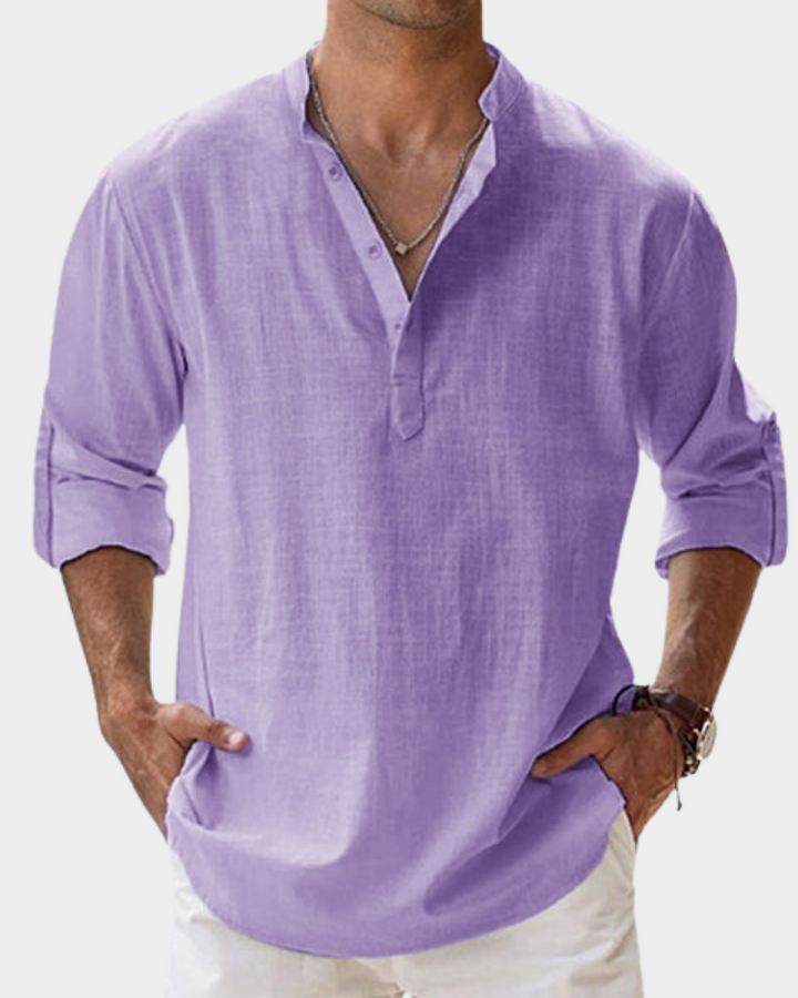 Man wearing a light purple long-sleeve shirt with rolled-up sleeves on a white background
