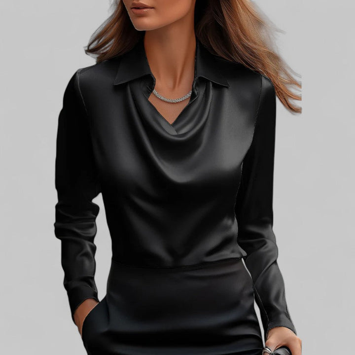 Black satin blouse worn by a model on a gray background