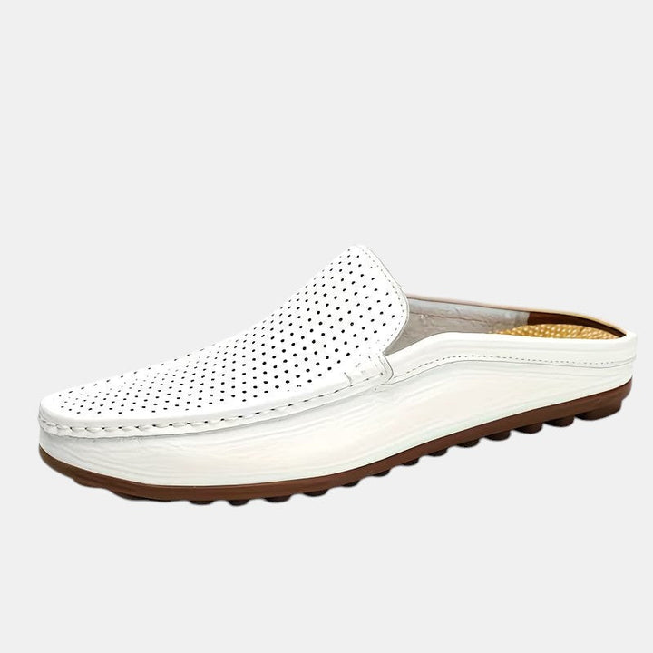 White loafer shoe with brown sole on a light gray background