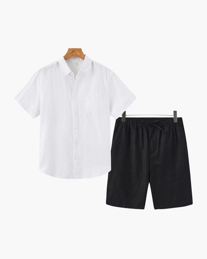 White shirt and black shorts on hangers against a white background