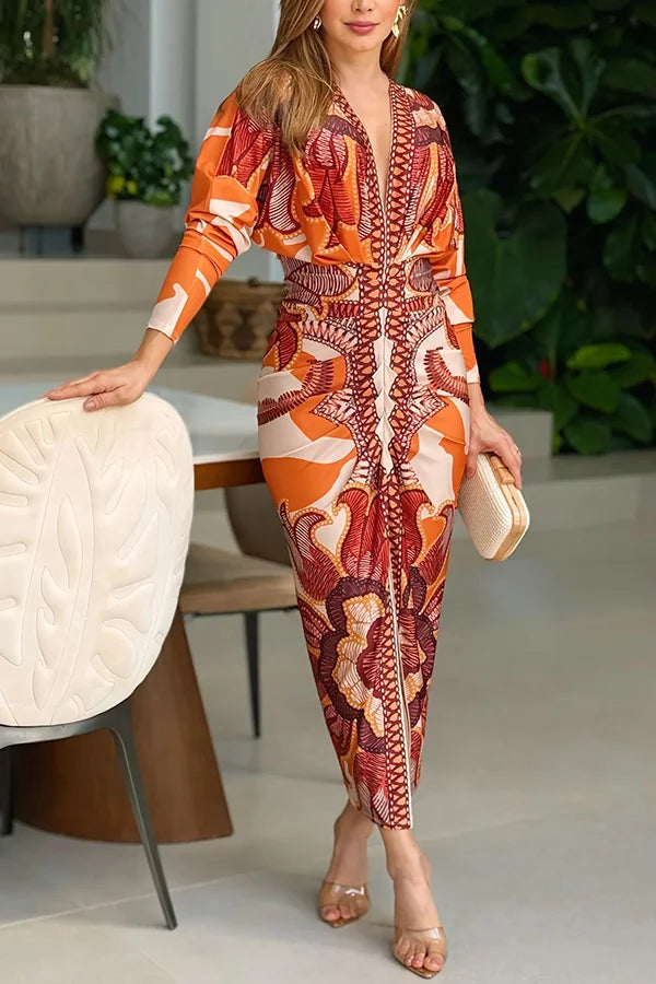 Woman wearing a patterned orange and brown jumpsuit in an indoor setting.