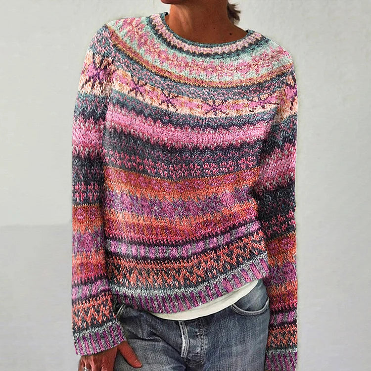 Multicolored striped sweater worn by a person on a plain background