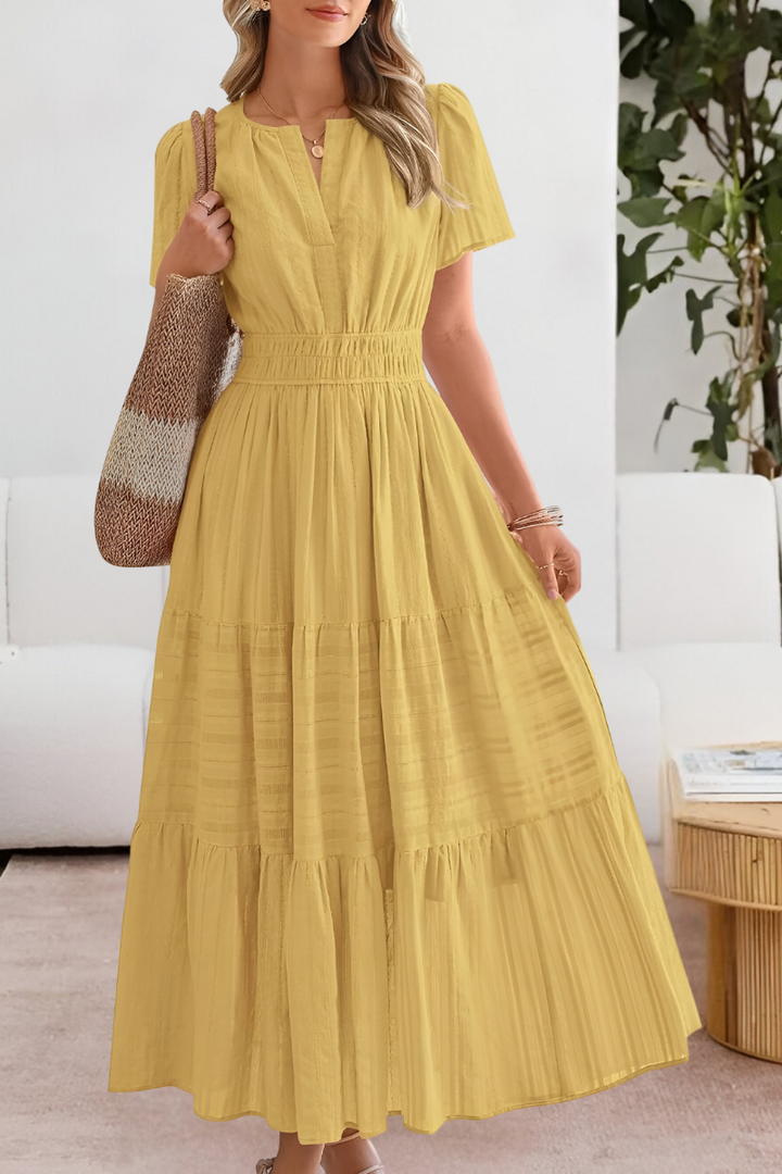 Woman wearing a yellow dress in an indoor setting