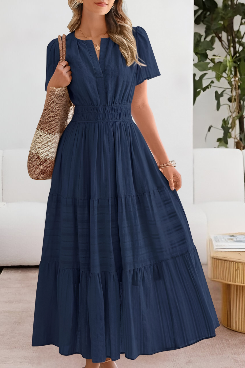 Woman wearing a navy blue dress in a home setting