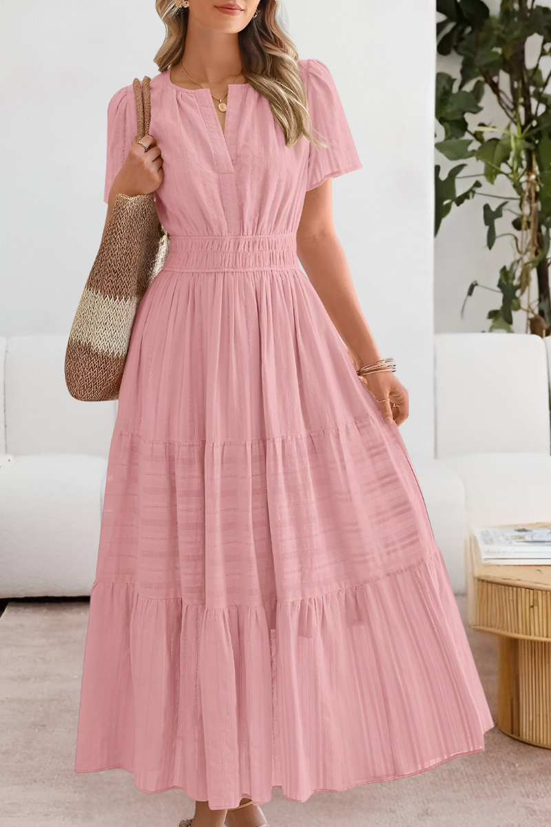 Woman wearing a pink dress in an indoor setting