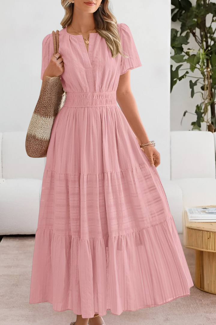 Woman wearing a pink dress in an indoor setting