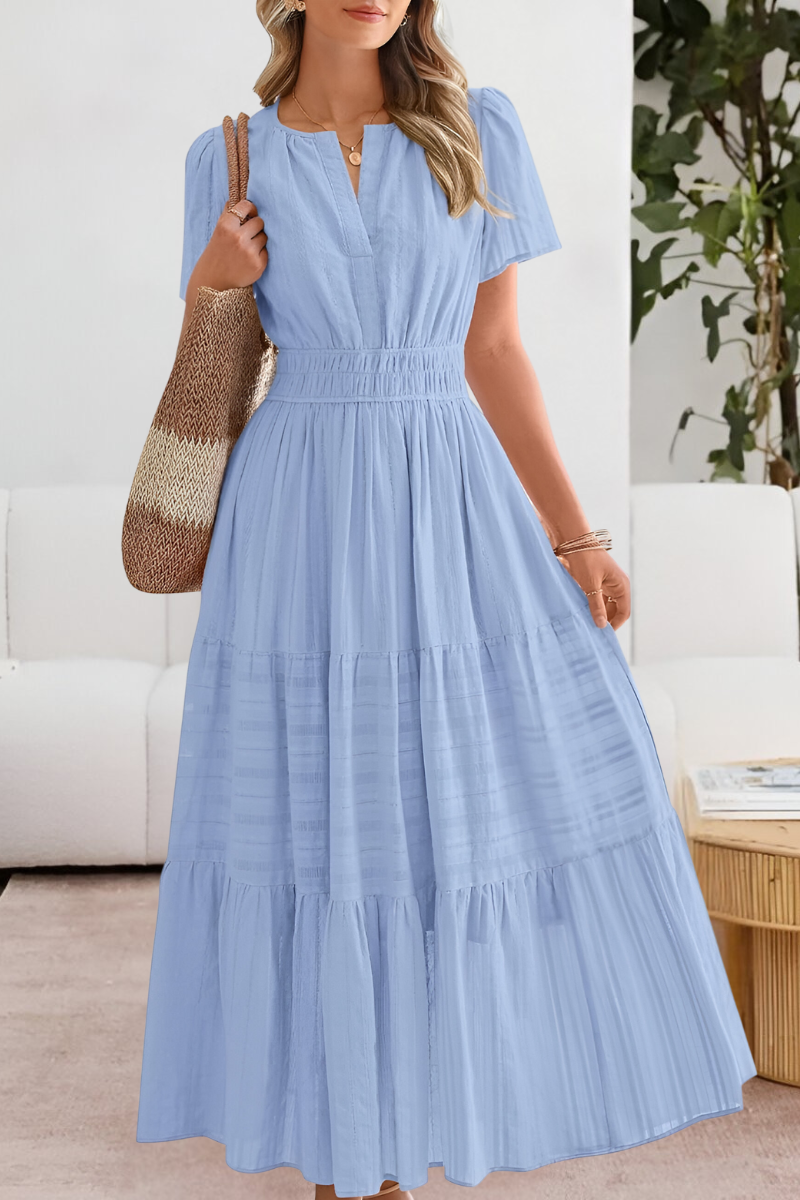 Woman wearing a light blue dress with a white background