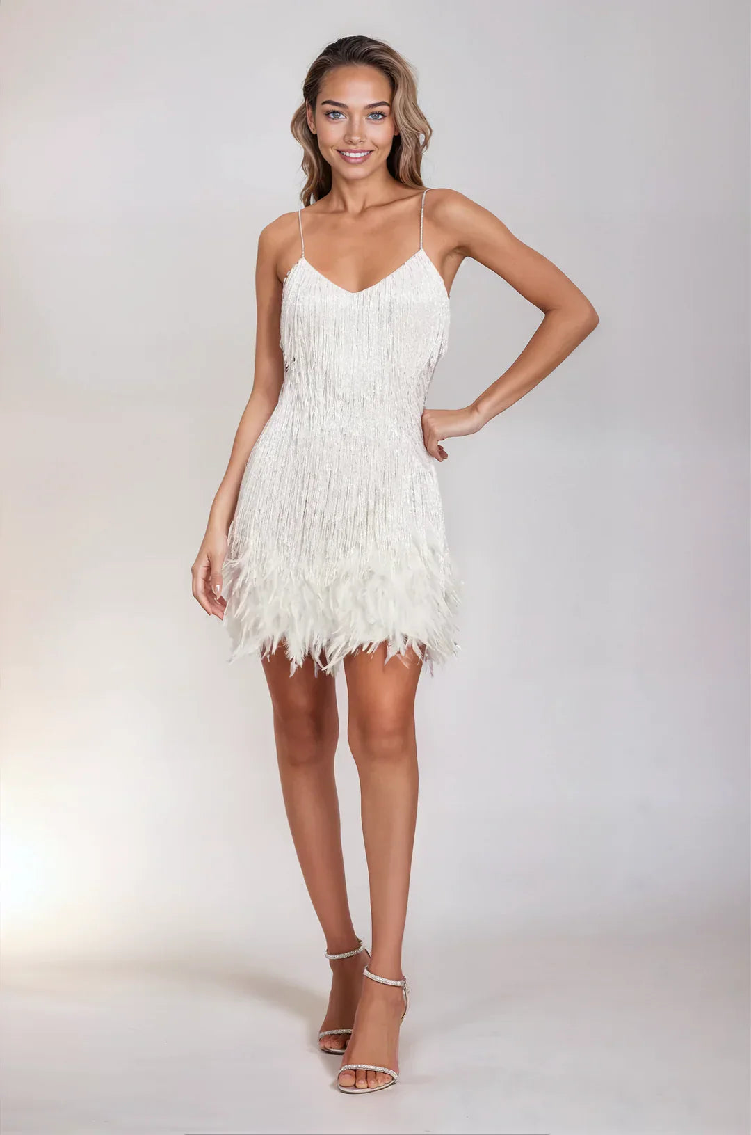 Woman wearing a white fringe dress on a plain background