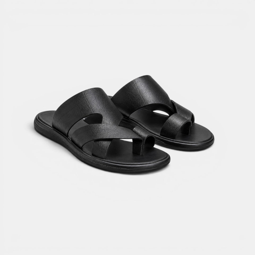 Pair of black sandals on a light gray background