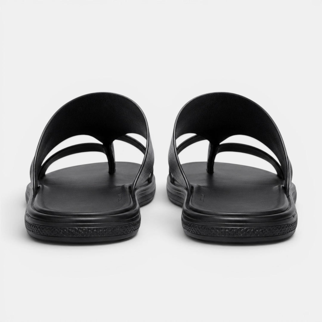 Pair of black sandals on a white background