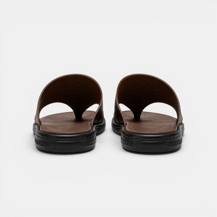 Pair of brown sandals with black soles on a white background
