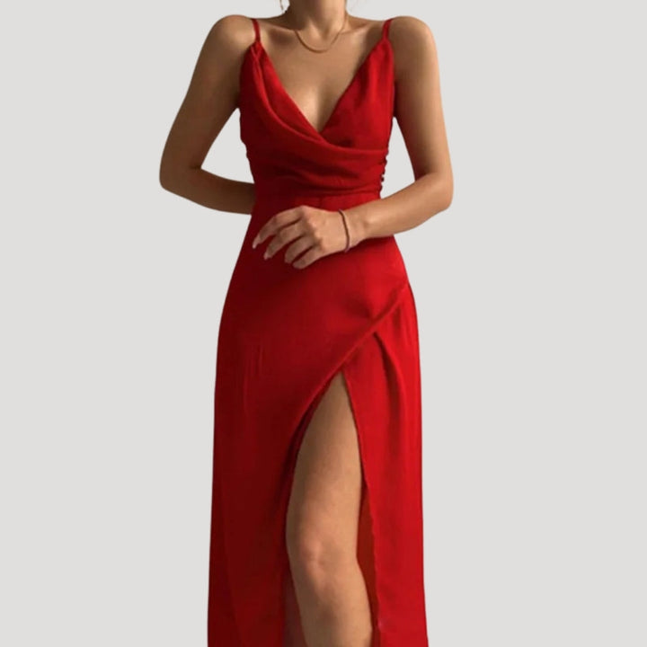 Red evening gown with a deep neckline and slit on a light gray background