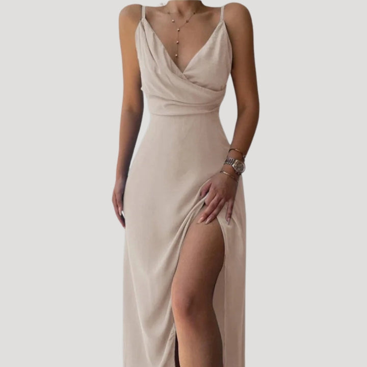 Beige evening gown with a slit on a plain background