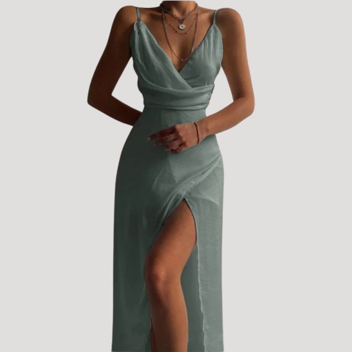 Green evening gown with a slit on a white background
