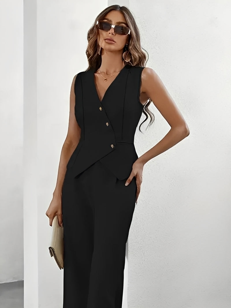 Woman wearing a black sleeveless blazer and pants against a white background
