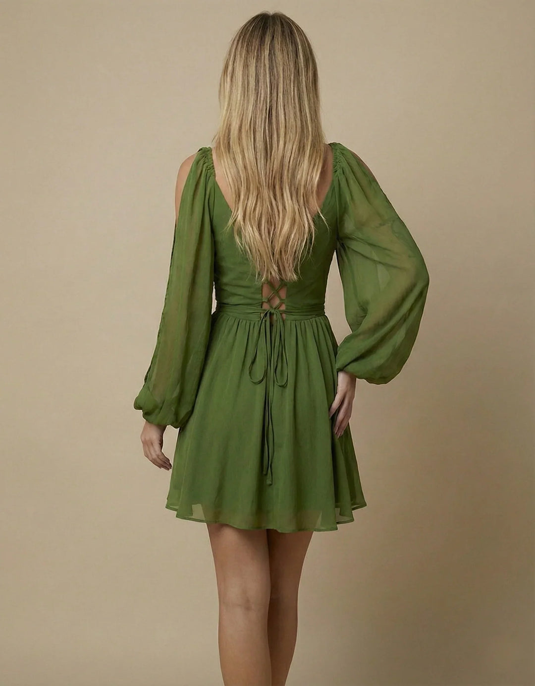 Green dress with long sleeves on a beige background
