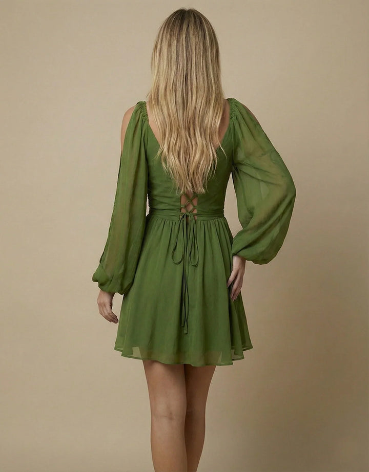 Green dress with long sleeves on a beige background