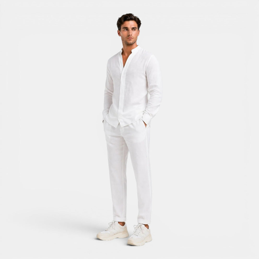 Man wearing a white linen shirt and pants on a white background