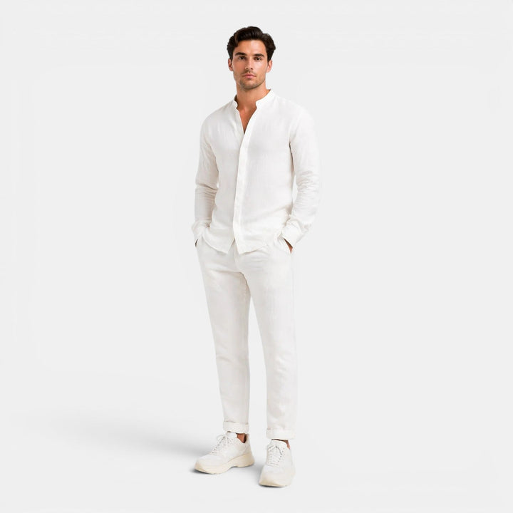 Man wearing a white outfit on a plain background