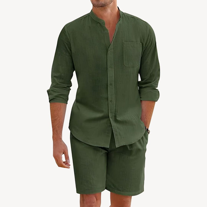 Man wearing a green shirt and shorts set on a white background