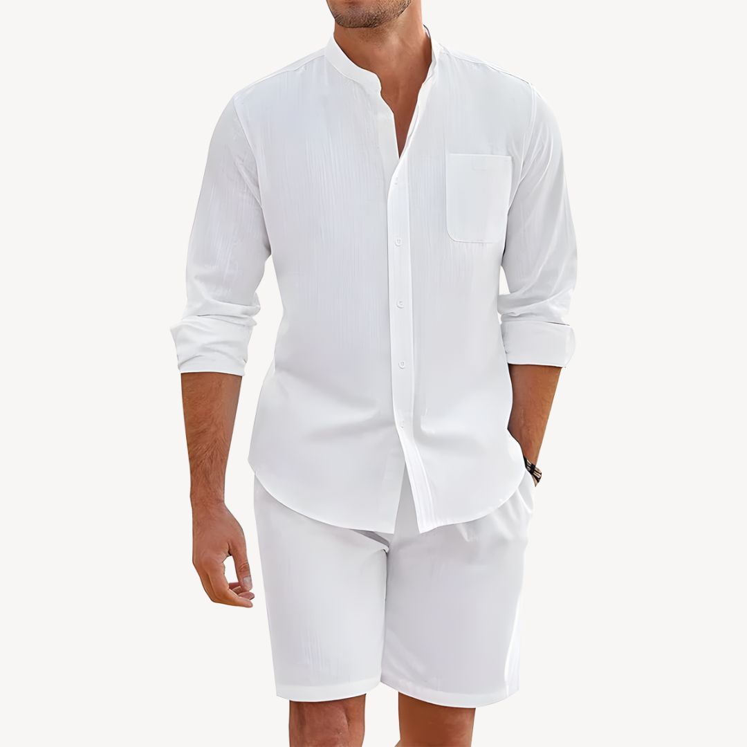 Man wearing a white long-sleeve shirt and white shorts on a white background