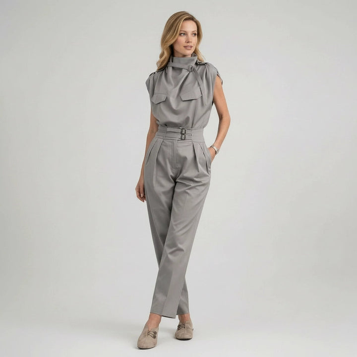 Woman wearing a gray jumpsuit on a white background